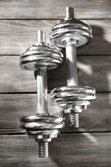 Big dumbbells on wooden background