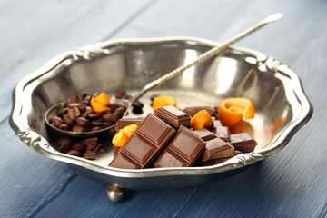 Chocolate with orange peels and coffee beans in metal tray