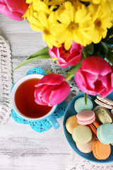 Obraz na płótnie Canvas Composition of spring flowers, tea and cookies on table