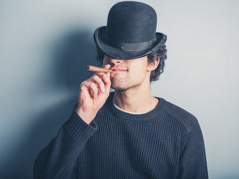 Young man smoking a cigar