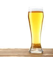 Glass of beer on wooden table, isolated on white