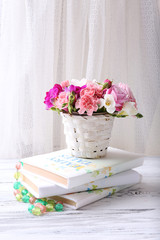 Beautiful fresh spring flowers with stack of books