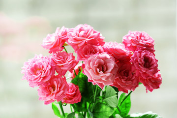 Bouquet of beautiful fresh roses on windowsill background