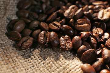 Pile of coffee beans on sackcloth, closeup