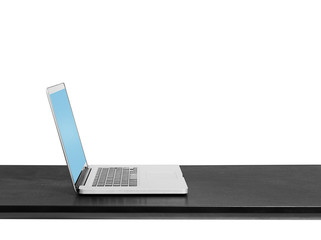 grey laptop on black table