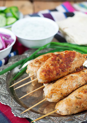 Chicken kebab with vegetables, sauce and pita