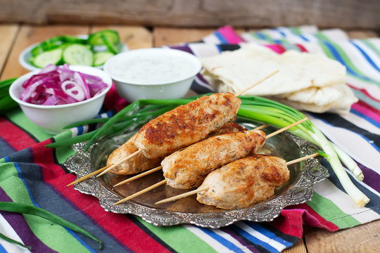 Chicken kebab with vegetables, sauce and pita