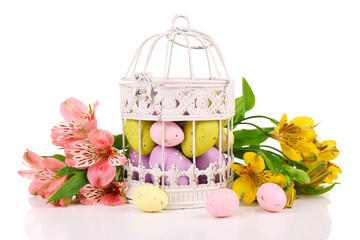 Easter composition with Easter eggs in decorative cage and