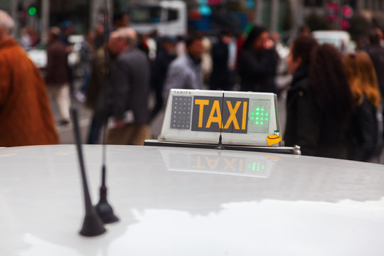 Taxischild mit Menschen im unscharfen Hintergrund