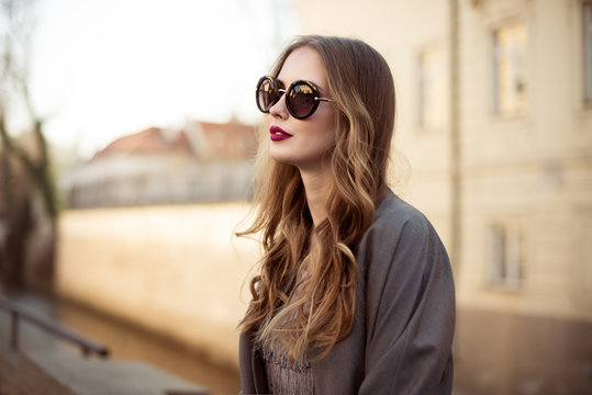 Beautiful young woman in sunglasses in the city