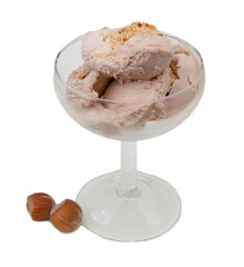 Cup of ice cream with hazelnut on white background