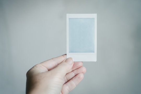 polaroid developing in a woman's hand