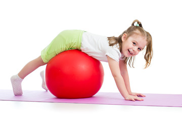 kid girl doing gymnastic exercise with fitball