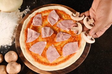 pizza and ingredients for pizza on the wooden background
