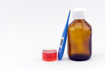 Cough syrup glass bottle with thermometer and dosage cup