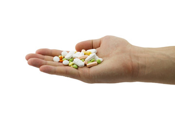 Heap of different pills, tablets and capsules in the man hand 
