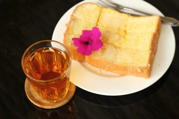 Bread, butter, topped  milk with tasty and tea