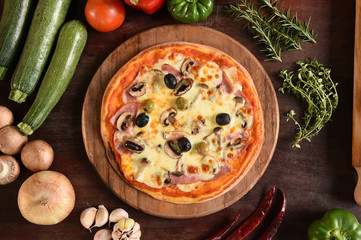Pizza with ham, mushrooms and olives.