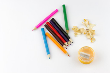 Top view of school supplies colored pencils,sharpener and pencil