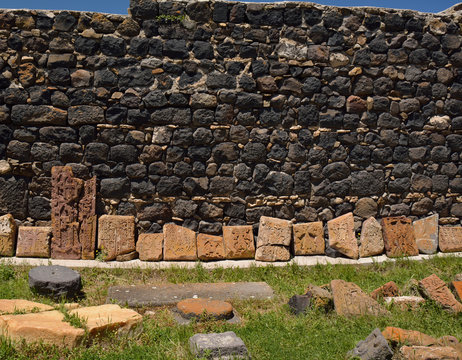 Row of broken khachkars next to the wall, Sevanavank