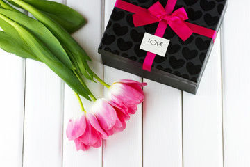 Pink tulips with gift box decorated pink ribbon and bow