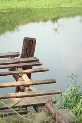 Old wooden bridge on the lake