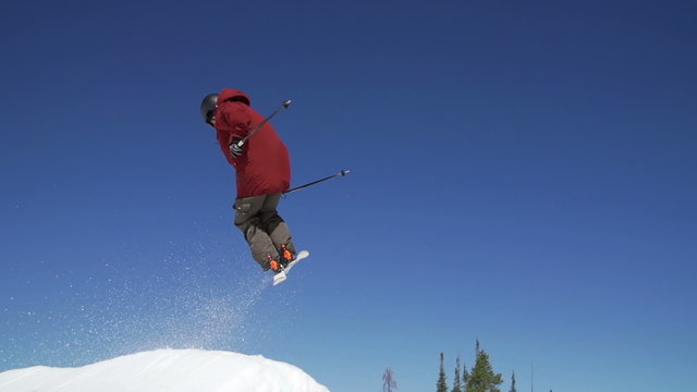 Slow Motion Man Skiing Doing Spin Off Jump 