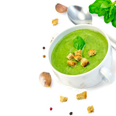 Soup puree with croutons and spoon in bowl