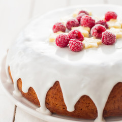 Banana Cake with Sugar Glaze Topped with Raspberries and Banana