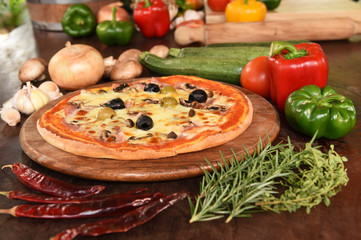 Pizza with ham, mushrooms and olives.
