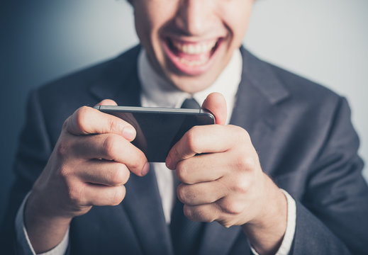Happy businessman using his smartphone