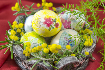 Fototapeta na wymiar Basket full of handcolored Easter Eggs in decoupage