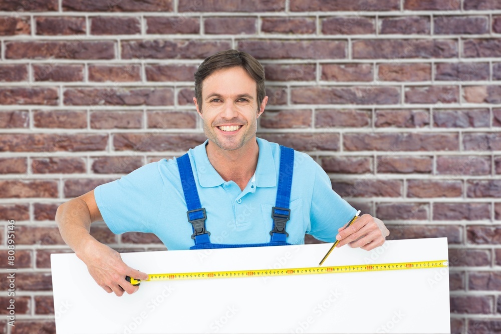 Poster composite image of happy carpenter measuring blank bill board