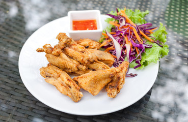 Tasty fried chicken in  white plates on glass table background