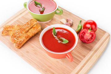 Bowl of tomato soup on a white background.
