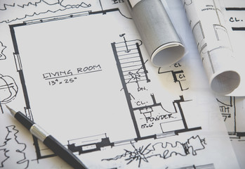 Architect rolls and plans construction project drawing