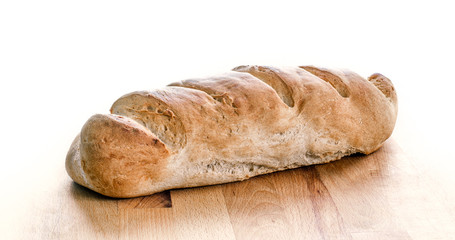 Loaf of whole wheat bread isolated on white. Home made organic c