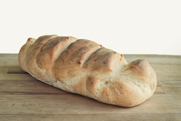 Loaf of whole wheat bread isolated on white. Retro look