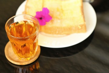 Bread, butter, topped  milk with tasty and tea
