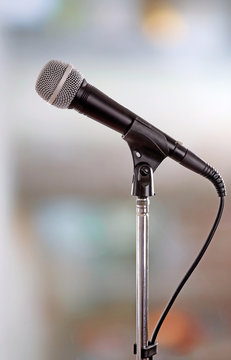 Microphone on stand on light background