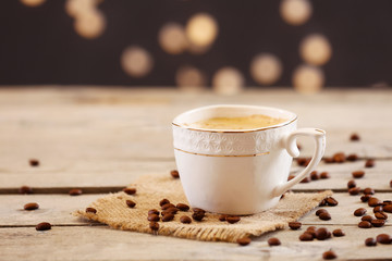 Cup of coffee on table on brown background