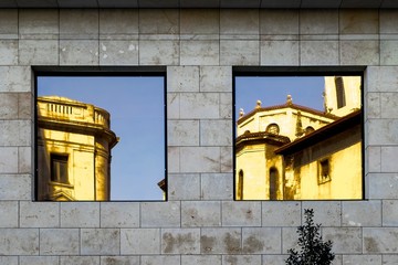 Windows and reflections on facade of building