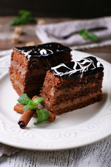 Tasty pieces of chocolate cake with mint and cinnamon