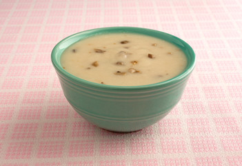 Bowl of cream of mushroom soup on table cloth