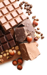 Chocolate bars with hazelnuts and coffee beans close up