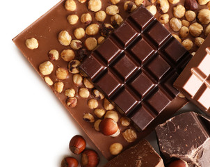 Black and milk chocolate bars with hazelnuts close up