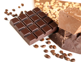 Chocolate bars with hazelnuts and coffee beans close up