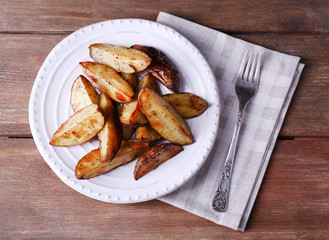 Baked potatoes on pate on wooden table