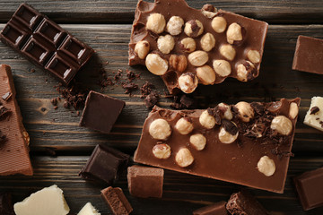 Set of chocolate with hazelnut on wooden table, top view