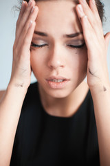 the upset woman touches with hands temples